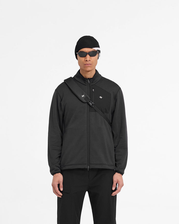 Man wearing a black fleece jacket on a plain white background | 247 Full Zip Fleece in Black | Regular fit fleece jacket with zip pockets | 247 Outerwear | Represent Clo