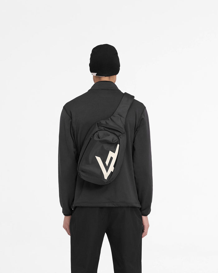 Man wearing a black zip fleece jacket on a plain white background | 247 Full Zip Fleece in Black | Fleece jacket with zip chest pocket and adjustable hem | 247 Outerwear | Represent Clo