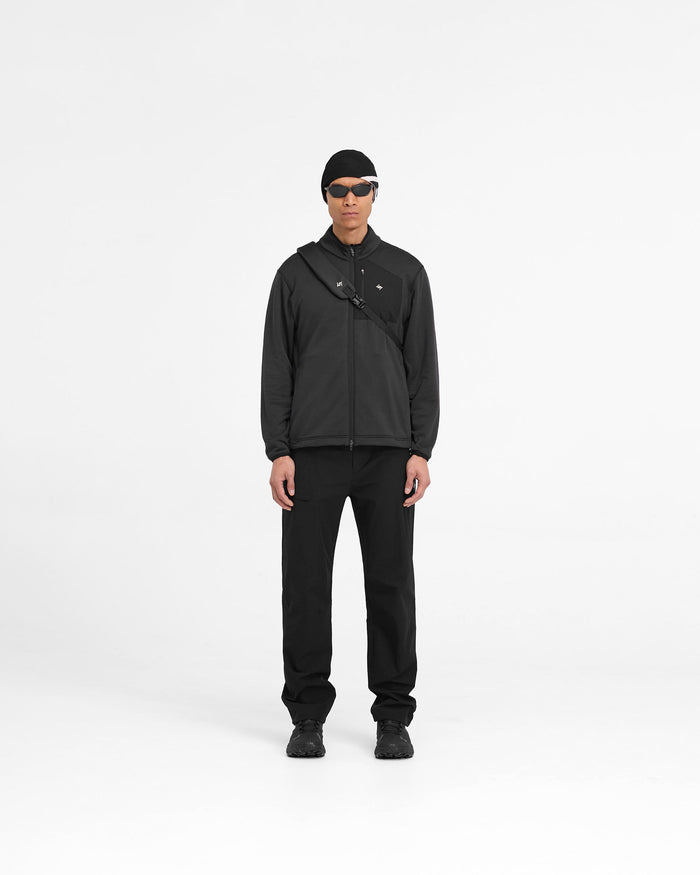 Man wearing a black fleece jacket on a plain white background | 247 Full Zip Fleece in Black | Fleece jacket with zip pockets and adjustable hem | 247 Outerwear | Represent Clo