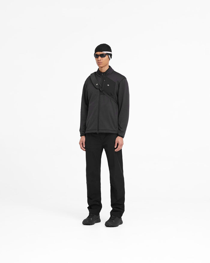 Man wearing a black full zip fleece on a plain white background | 247 Full Zip Fleece in Black | Fleece with zip pockets and adjustable hem | 247 Outerwear | Represent Clo