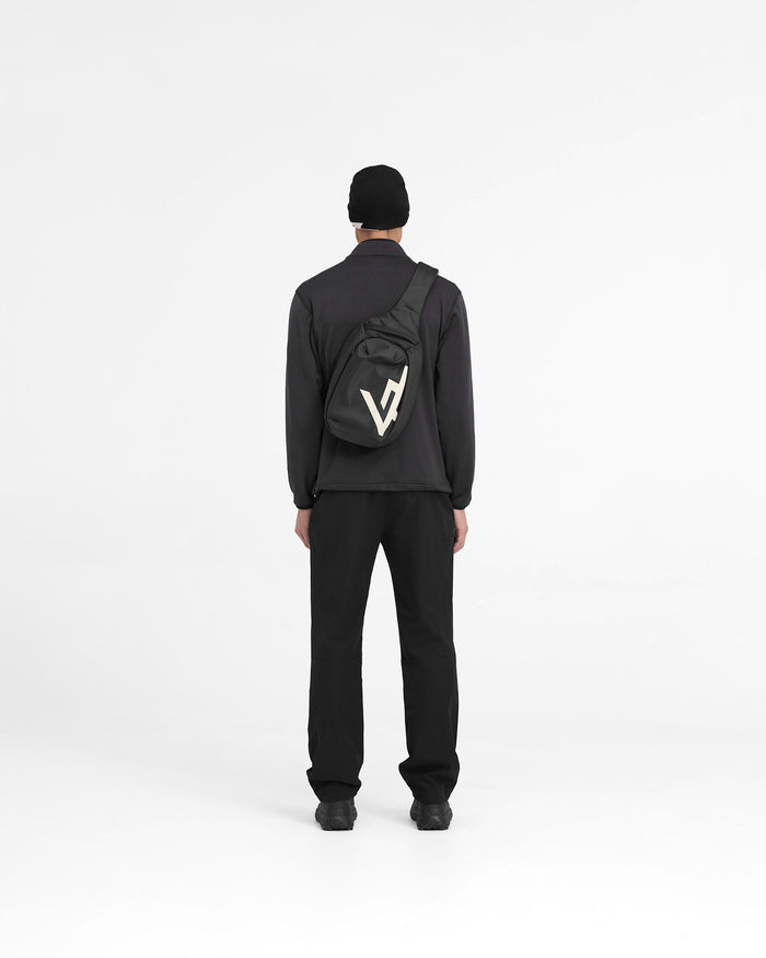 Man wearing a black full zip fleece jacket on a plain white background | 247 Full Zip Fleece in Black | Fleece jacket with zip pockets and adjustable hem | 247 Outerwear | Represent Clo