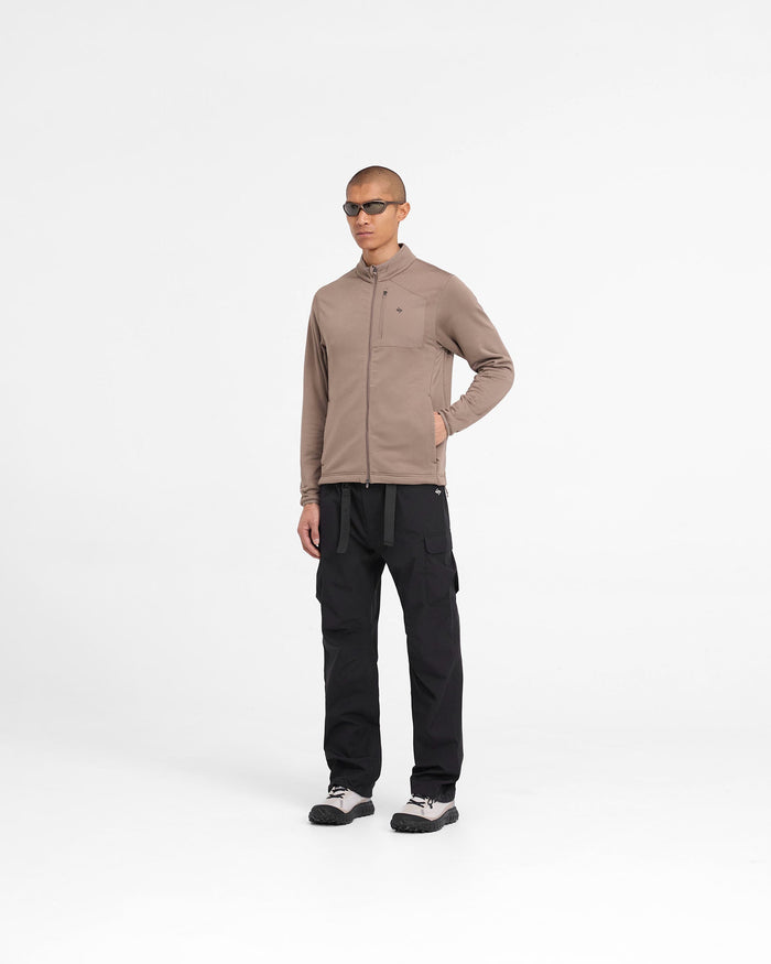 Man wearing a brown fleece jacket on a plain white background | 247 Full Zip Fleece in Umber | Fleece jacket with zip pockets and adjustable hem | 247 Outerwear | Represent Clo