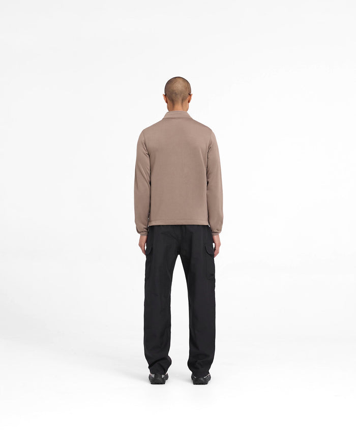 Man wearing a brown fleece jacket on a plain white background | 247 Full Zip Fleece in Umber | Fleece jacket with zip closure and chest pocket | 247 Outerwear | Represent Clo