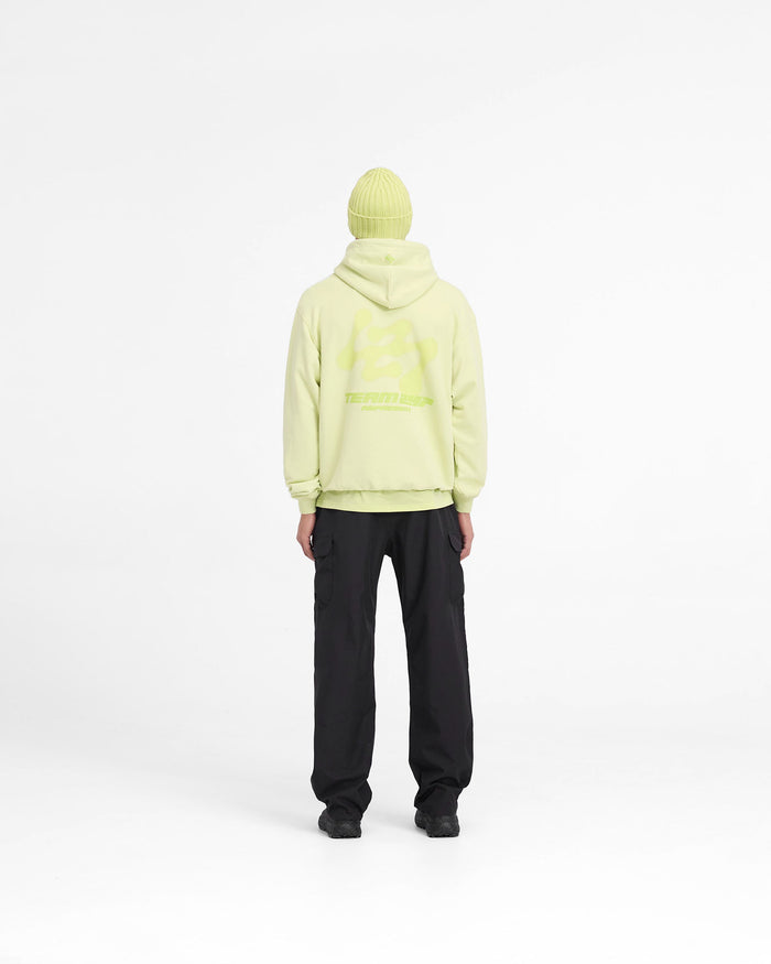 Man wearing an oversized lime hoodie on a plain white background | 247 Future Terrains Oversized Hoodie in Shadow Lime | Heavyweight cotton hoodie with Team 247 branding | 247 Hoodies | Represent Clo