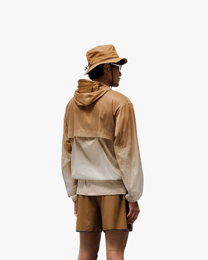 Man wearing an ombre hooded training jacket on a plain white background | 247 Hooded Training Jacket in Ombre | Polyester jacket with water resistance and adjustable hem | 247 Outerwear | Represent Clo