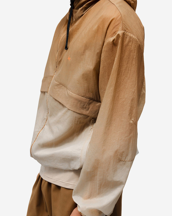Man wearing a grey hooded training jacket on a plain white background | 247 Hooded Training Jacket in Ombre | Performance outerwear with DWR coating | 247 Outerwear | Represent Clo