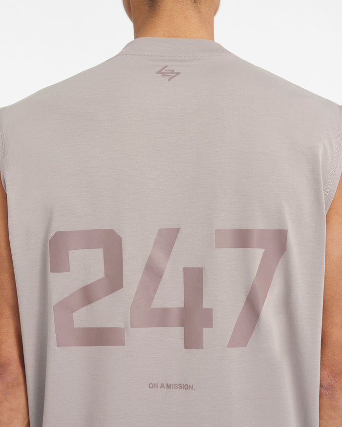 Man wearing a grey oversized tank top on a plain white background | 247 Oversized Tank in Cinder | Lightweight tank with 4-way stretch | 247 T-Shirts | Represent Clo