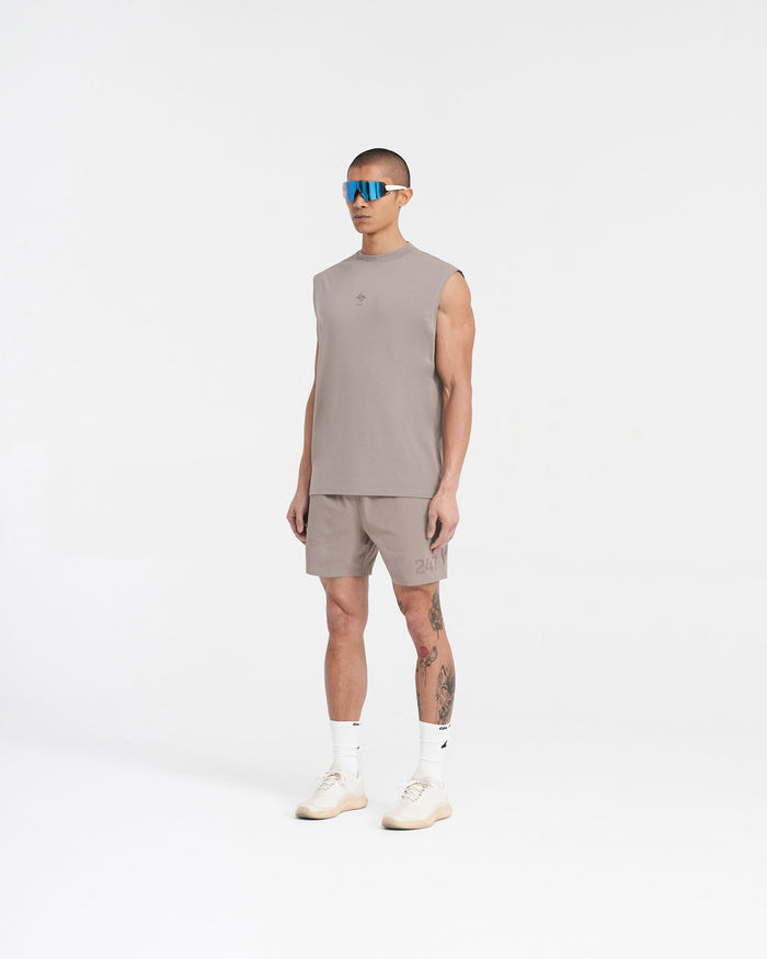 Man wearing a grey oversized tank top on a plain white background | 247 Oversized Tank in Cinder | Lightweight tank with 4-way stretch and quick-drying | 247 T-Shirts | Represent Clo