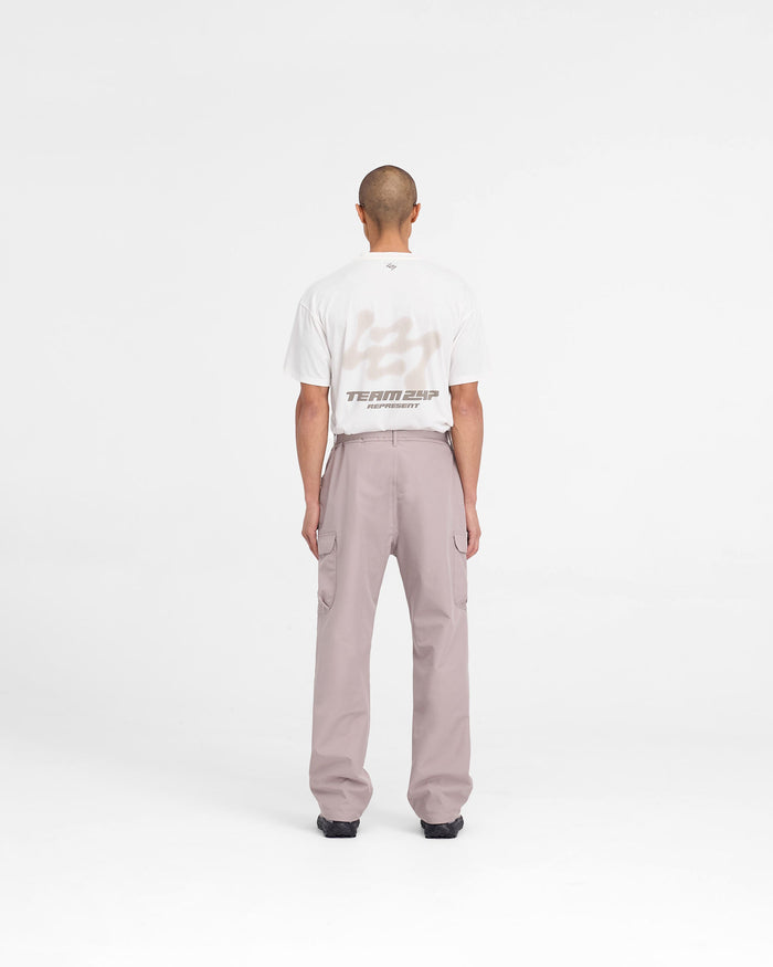 Man wearing grey cargo pants on a plain white background | 247 Technical Cargo Pant in Moonrock | Technical cargo pants with waterproof tapes | 247 Pants | Represent Clo