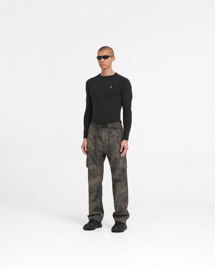 Man wearing a green technical cargo pant on a plain white background | 247 Technical Cargo Pant in Terrain | Straight leg cargo pants with waterproof tapes and maglock buckle | 247 Pants | Represent Clo