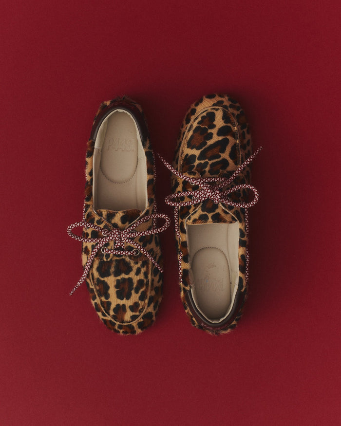 Side angle of leopard and burgundy/brown boat shoe
