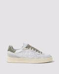 Side angle of white and green sneakers