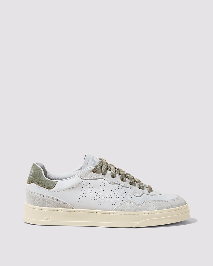Side angle of white and green sneakers