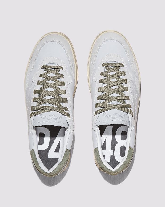 Front angle of white and green sneakers