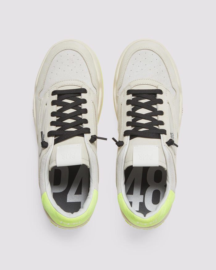 Front angle of beige and yellow sneakers