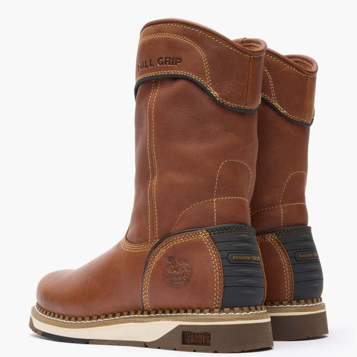 Pair of brown work boots with visible branding on a white background
