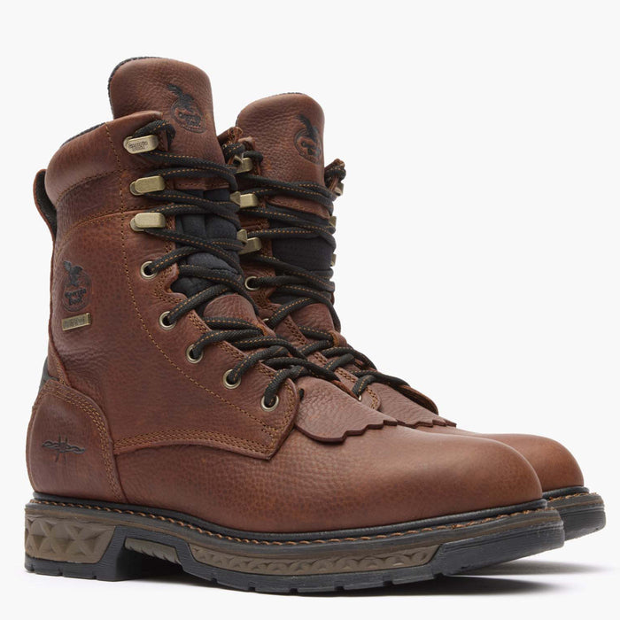 Pair of brown leather boots with laces on a white background