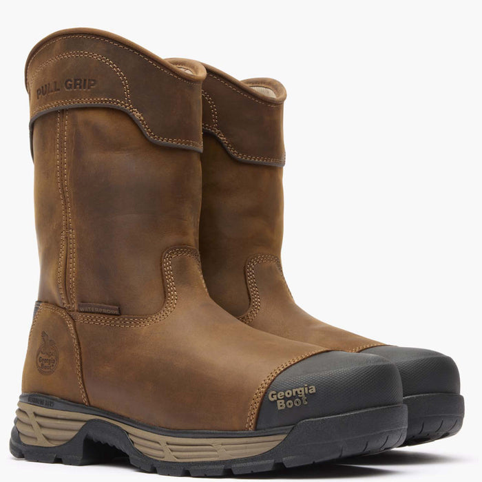 Pair of brown work boots with black soles on a white background