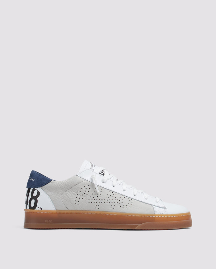 Side angle of beige and navy sneakers