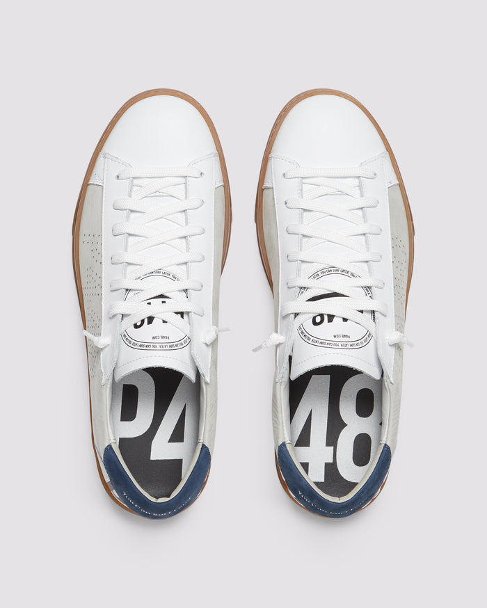 Front angle of beige and navy sneakers