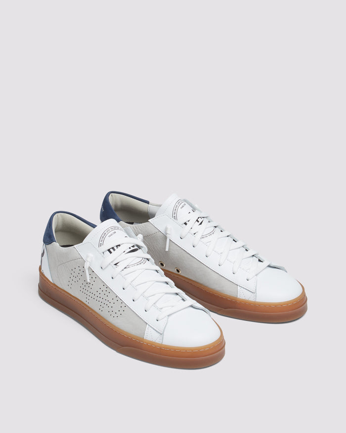 Back angle of beige and navy sneakers