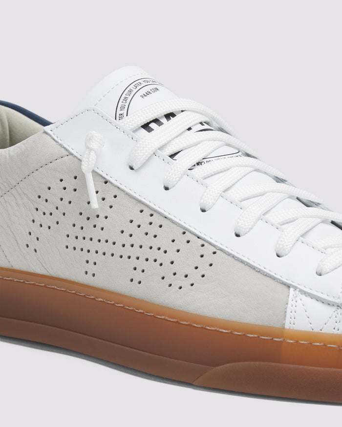 Side angle of beige and navy sneakers