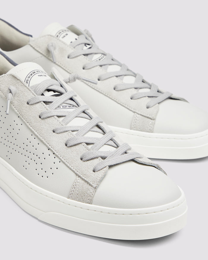 Side angle of white and blue sneakers