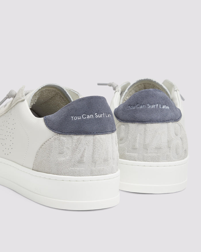 Side angle of white and blue sneakers