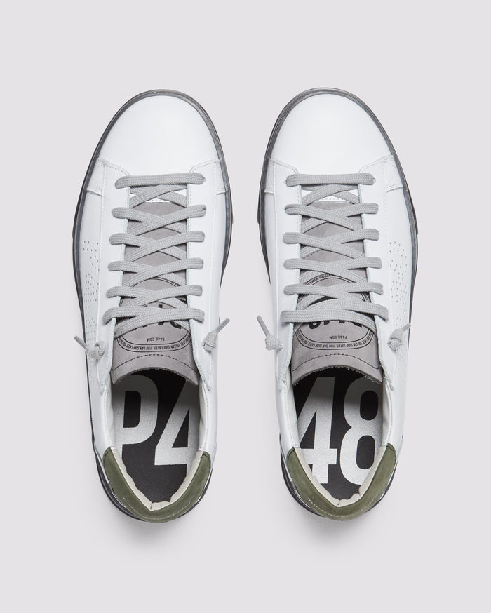 Front angle of white and green sneakers