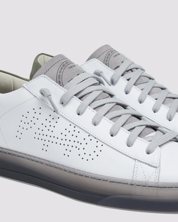 Side angle of white and green sneakers