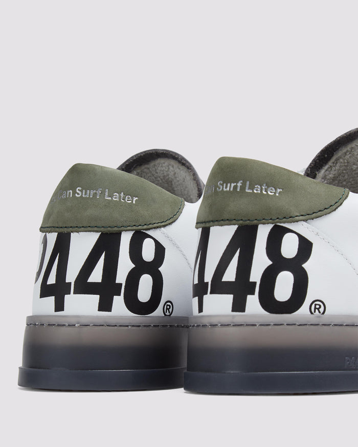 Side angle of white and green sneakers