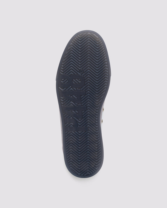 Bottom angle of white and green sneakers