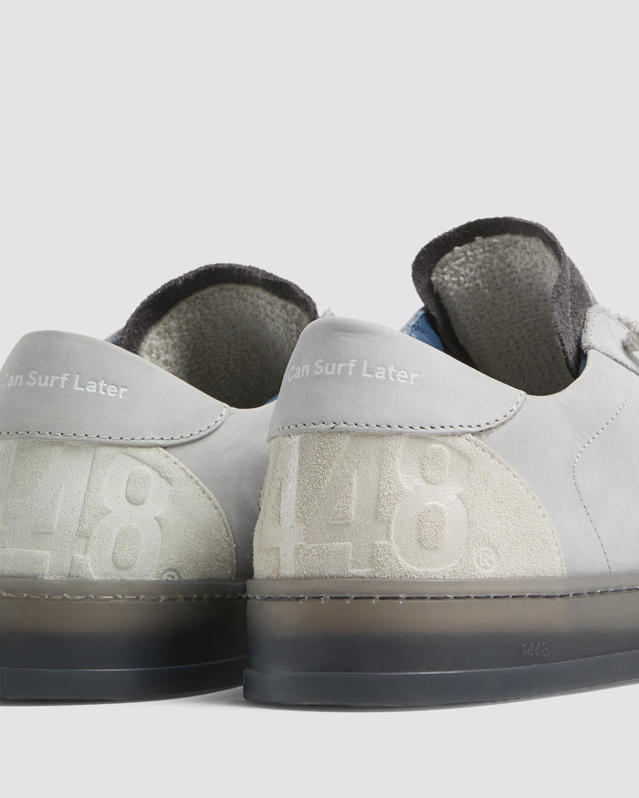 Bottom angle of grey sneakers