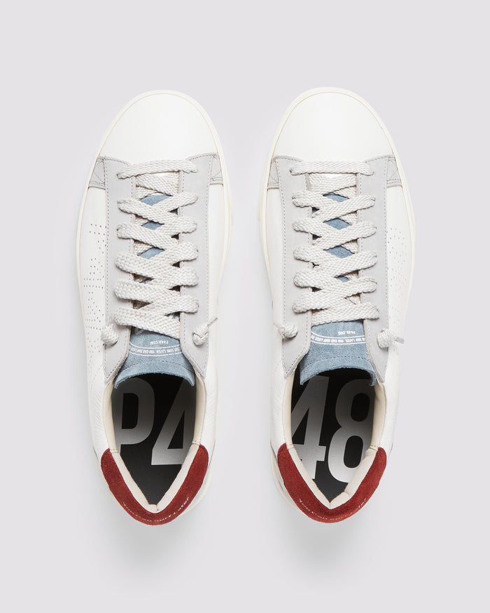 Front angle of white, burgundy and blue sneakers