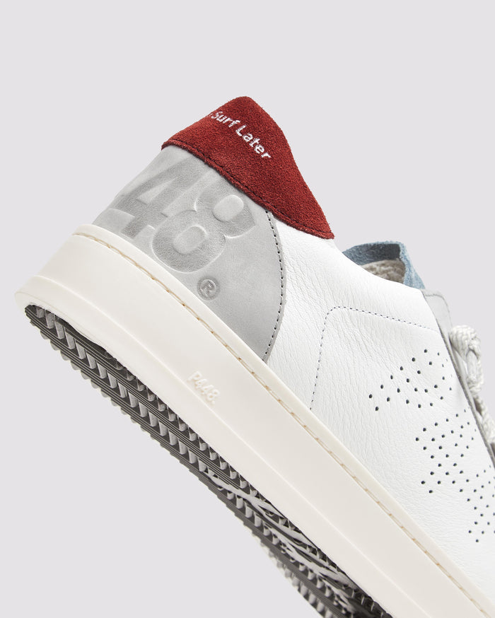 Side angle of white, burgundy and blue sneakers