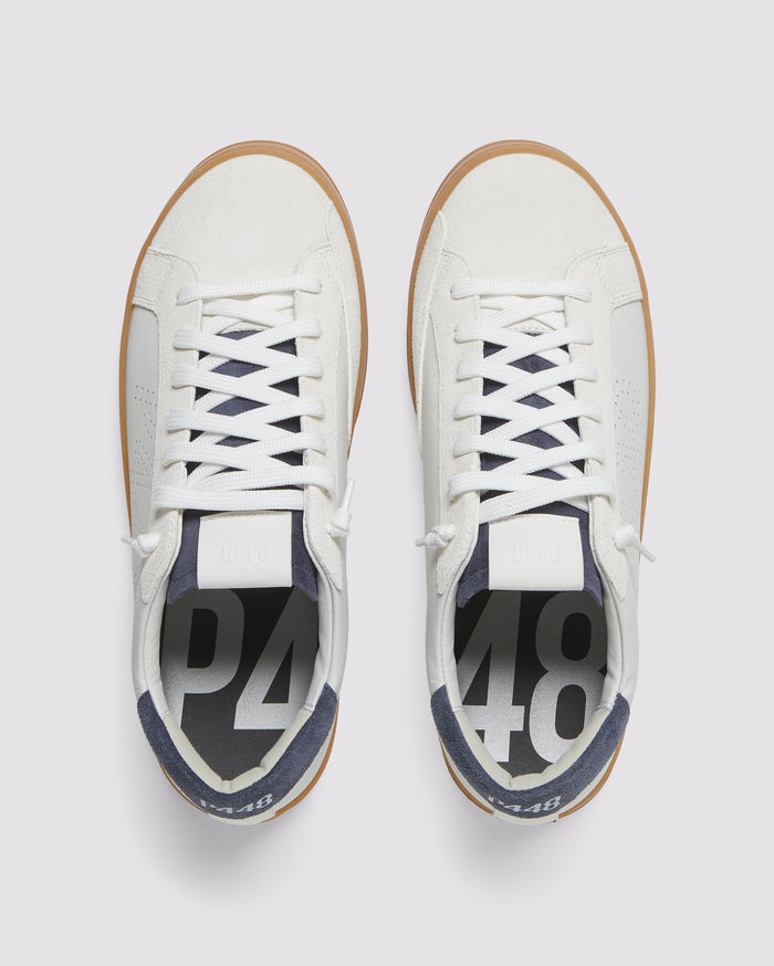 Front angle of white and navy sneakers