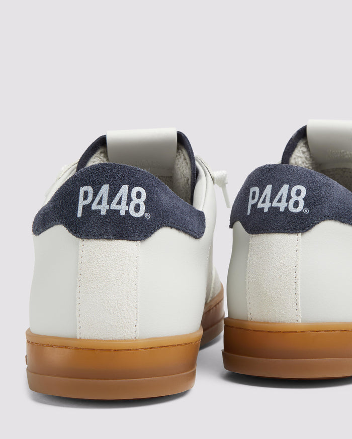 Side angle of white and navy sneakers