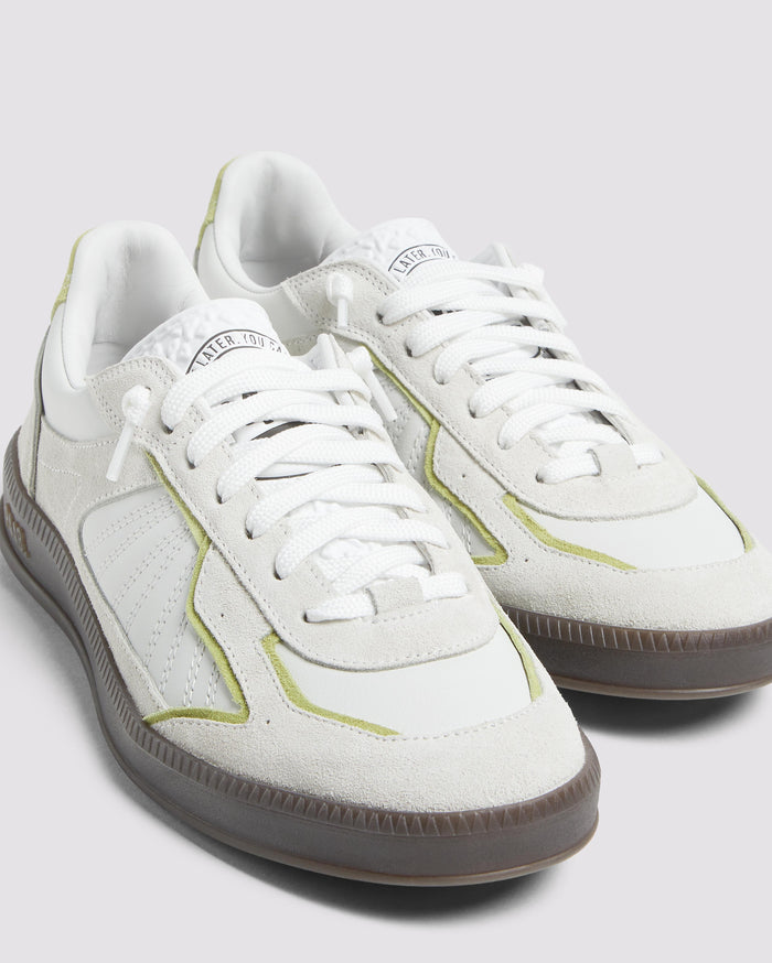 Side angle of green and white sneakers