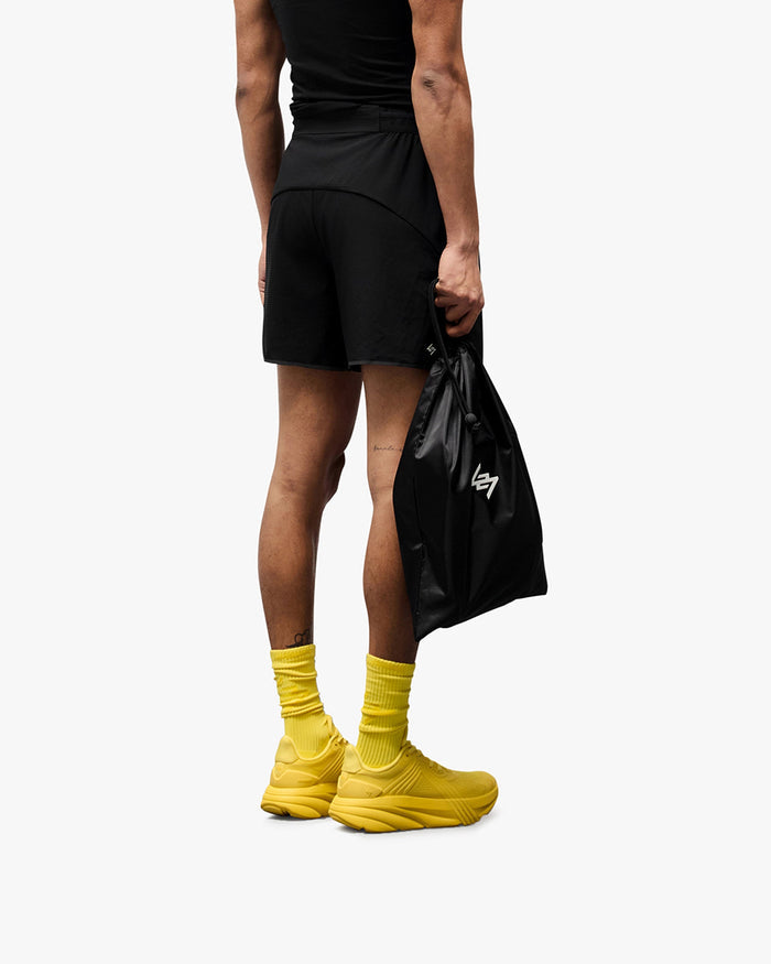 Man wearing black running shorts on a plain white background | Team 247 Aero Short in Black | Lightweight breathable shorts with branded waistband and zip pockets | 247 Shorts | Represent Clo