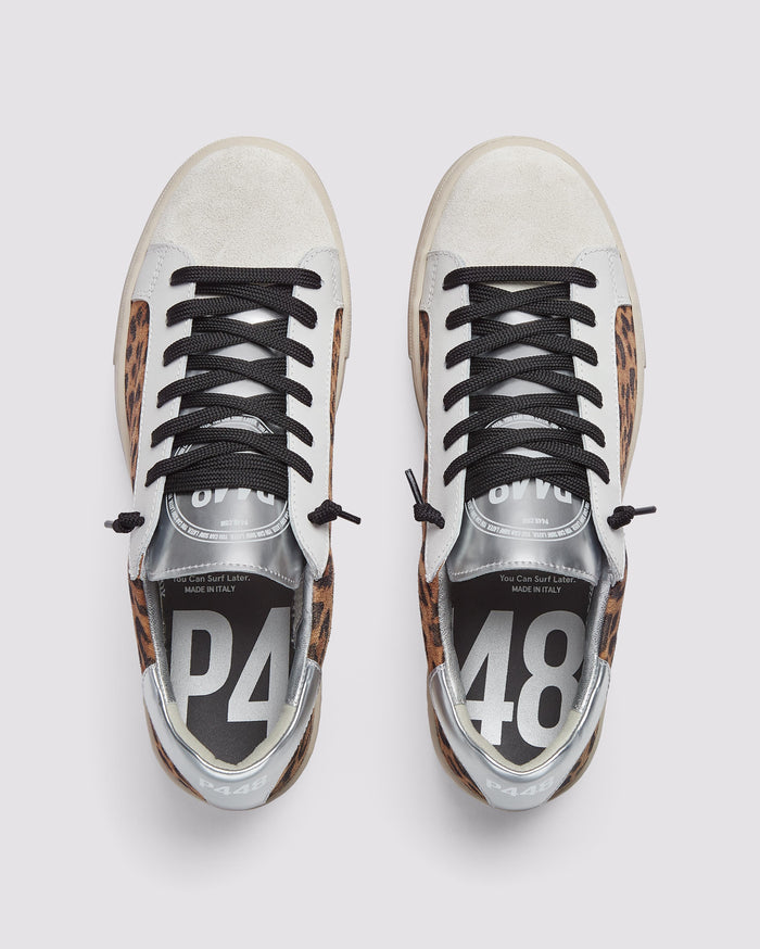 Front angle of black and brown leopard and silver platform sneakers
