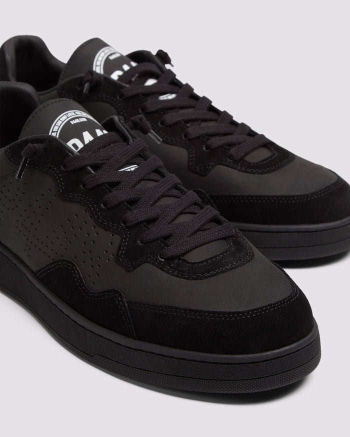 Side angle of black sneakers