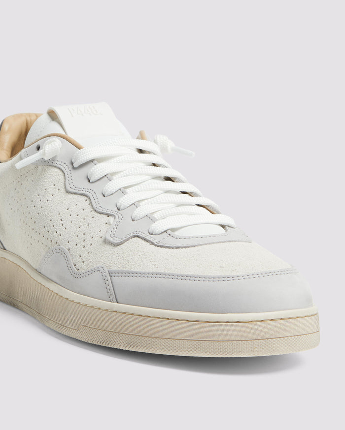 Side angle of white and grey sneakers
