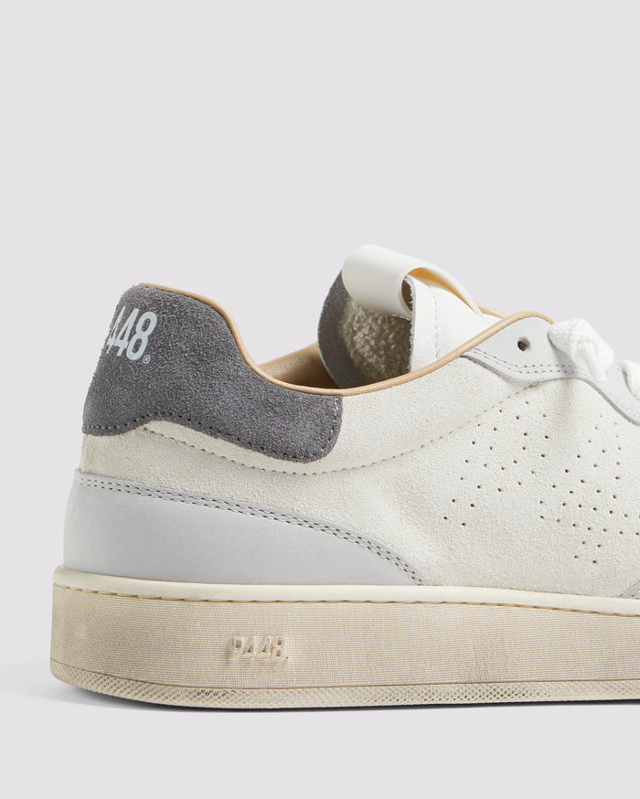 Side angle of white and grey sneakers